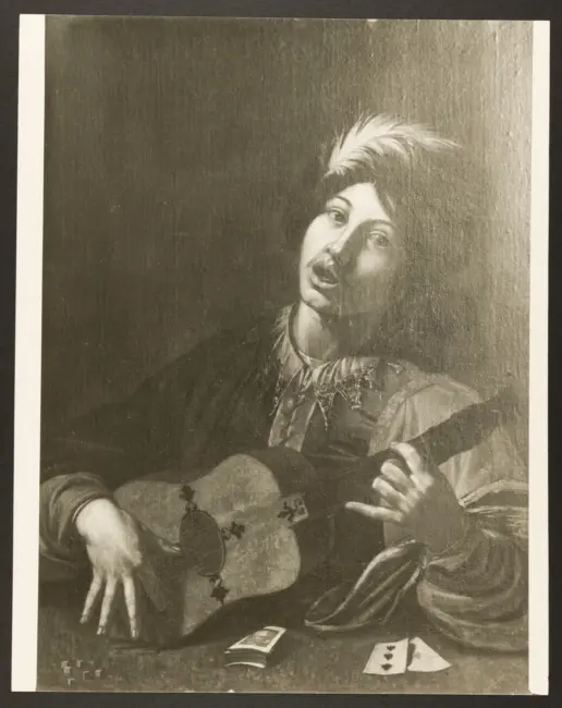 Suonatore di chitarra con dadi e carte