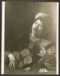 Suonatore di chitarra con dadi e carte